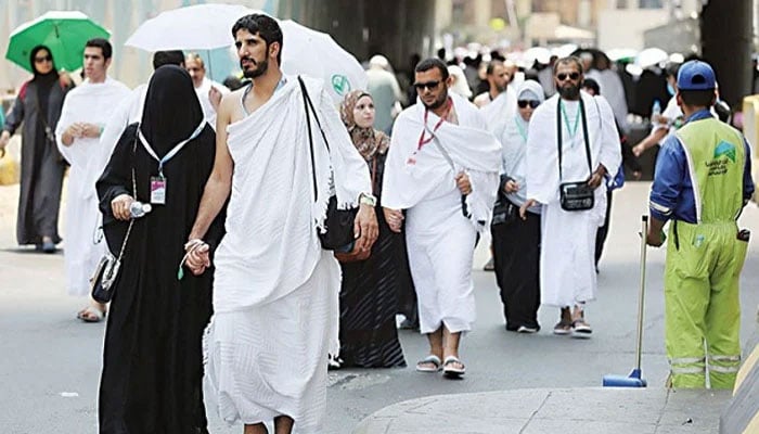 Pilgrims walk on a street in Makkah. — AFP/file