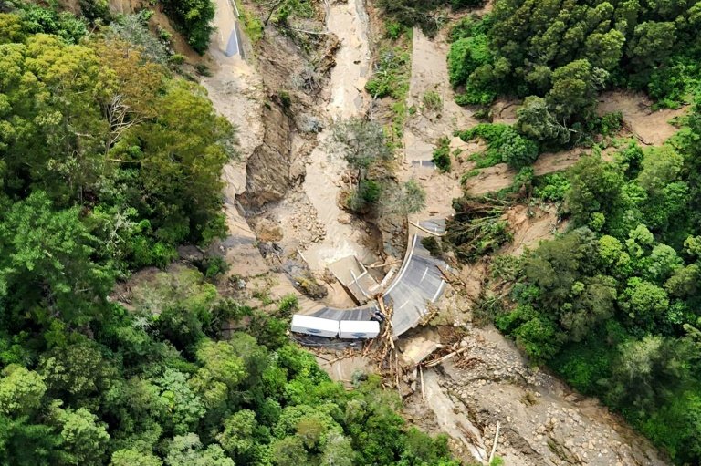 A New Zealand Defence Force photo shows a truck stranded on a road covered with debris near Wairoa on the east coast of New Zealands North Island. — New Zealand Defence Force/AFP
