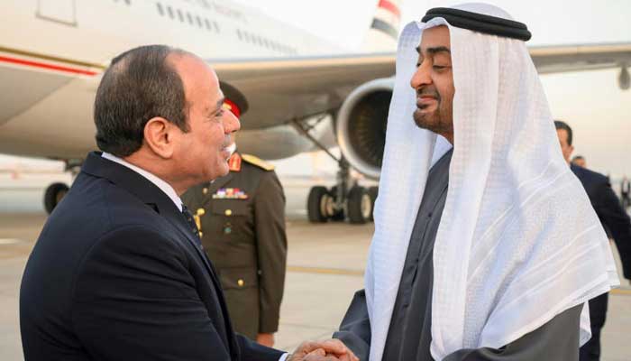 A handout picture released by the United Arab Emirates presidential court shows Emirati President Sheikh Mohamed bin Zayed Al-Nahyan (R) welcoming Egypts President Abdel Fattah al-Sisi in Abu Dhabi on February 12, 2023. — AFP