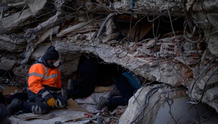 Rescue personnel search the rubble of collapsed buildings in Hatay, on February 14, 2023.— AFP