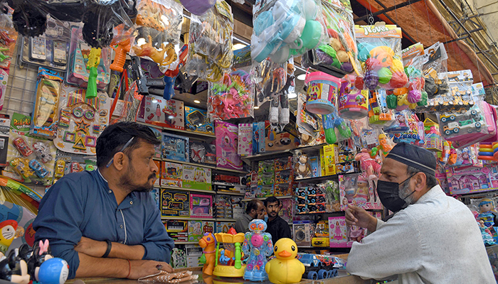A vendor stands at a kids toys shop in a market in Karachi on February 15, 2023. — APP