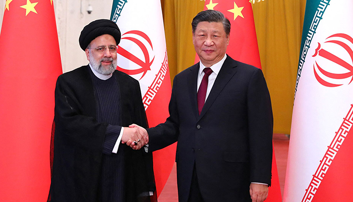 This handout picture provided by the Iranian presidency shows Chinese President Xi Jinping welcoming the Islamic Republics President Ebrahim Raisi (left) during his visit to Beijing on February 14, 2023.—  AFP