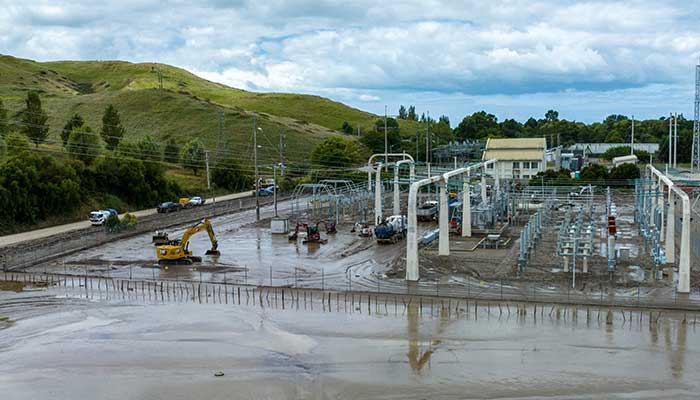 Workers clear the mud and debris from the Redclyffe Substation following Cyclone Gabrielle in Napier on February 17, 2023. — AFP/File