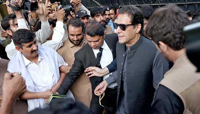 PTI Chairman and former prime minister Imran Khan coming out of a court after a hearing in this undated photo. — APP/File