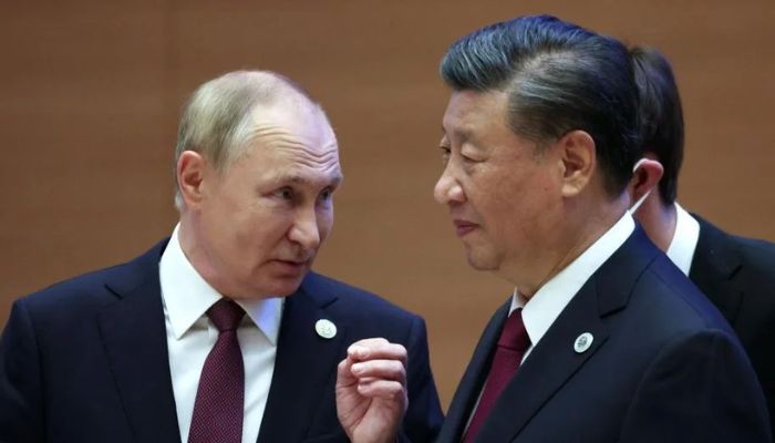 Russian President Vladimir Putin speaks to Chinas President Xi Jinping during the Shanghai Cooperation Organisation leaders summit.— AFP