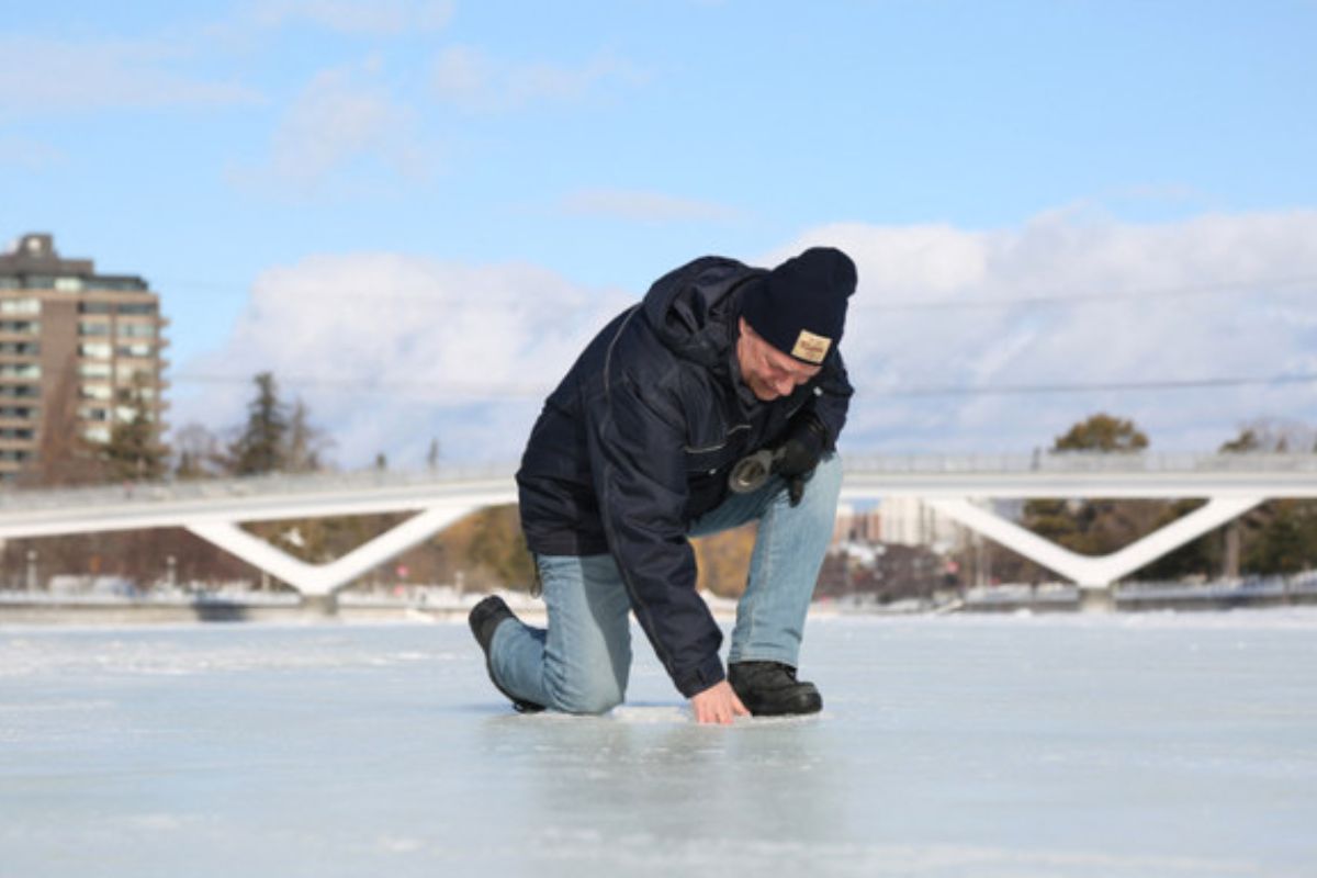 Bruce Devine, senior manager facilities and programs at the National Capital Commission checks the ice condition on the Rideau Canal on February 8, 2023 in Ottawa, Canada.— AFP