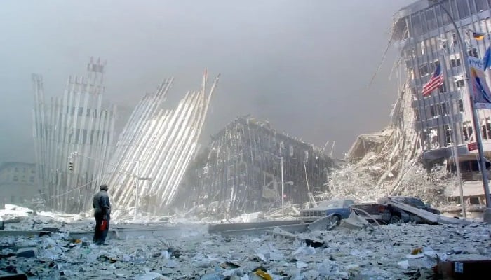 A man stands in the rubble after the collapse of the first World Trade Center Tower in New York City on September 11, 2001. — AFP/ File