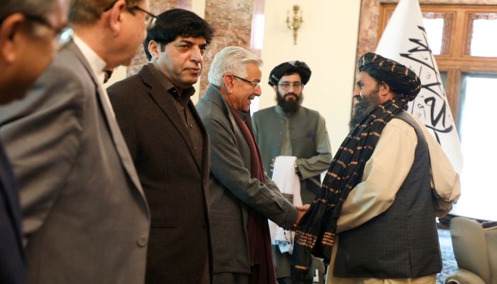Defence Minister Khawaja Asif (left) shakes hands with Afghanistan’s acting deputy prime minister for economic affairs Abdul Ghani Baradar. — Twitter/ @FDPM_AFG