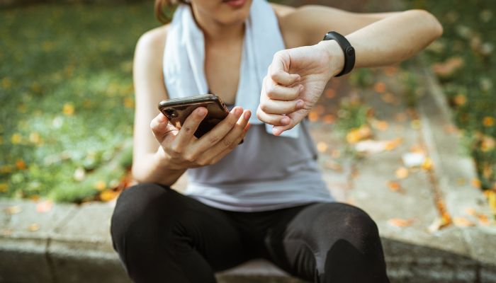 Woman using devices for pulse controlling.— Pexels