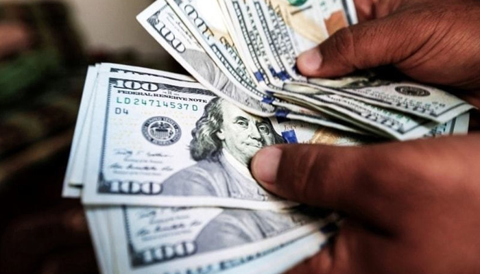 A person counts $100 bills.  — AFP/File