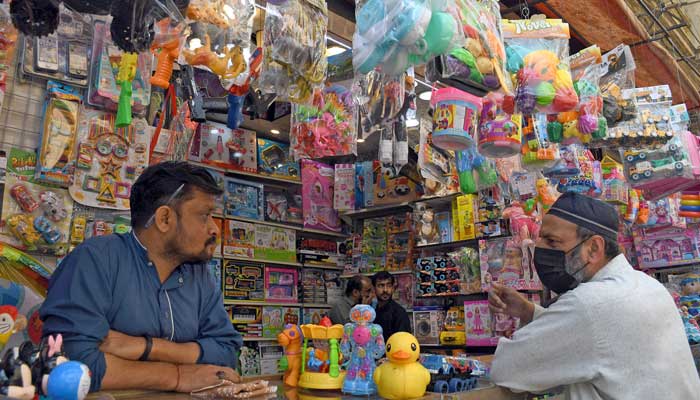 A vendor stands in his kids toys shop in a market in Karachi on February 15, 2023. — Online