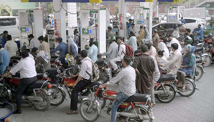 A large number of bike owners stand in a queue at a petrol pump in Islamabad on June 7, 2022. — APP