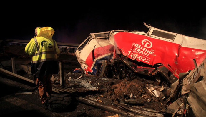 A man walks at the site of a crash, where two trains collided, near the city of Larissa, Greece, March 1, 2023. Agencies