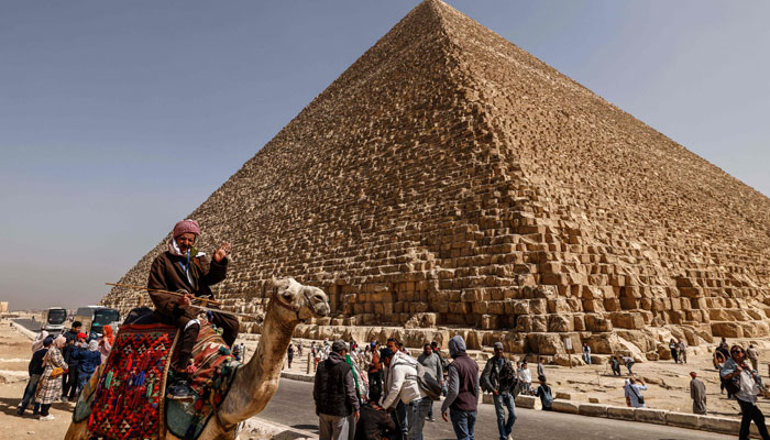 Tourists visit the Great Pyramid of Khufu (Cheops) at the Giza Pyramids necropolis on the southwestern outskirts of Cairo, on March 2, 2023.—AFP