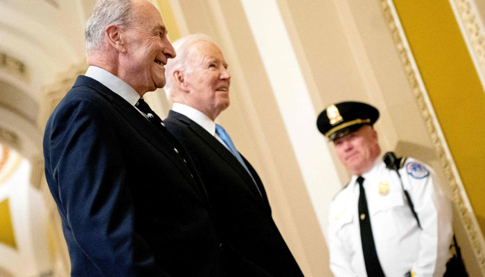 US President Joe Biden talks with Senate Majority Leader Chuck Schumer (D-NY) as he arrives for the Senate Democratic Caucus policy luncheon at the US Capitol in Washington, DC, on March 2, 2023. AFP