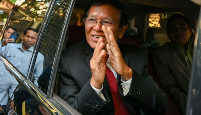 Kem Sokha, former leader of the now-dissolved Cambodia National Rescue Party, greets media before his Friday sentencing hearing.— AFP