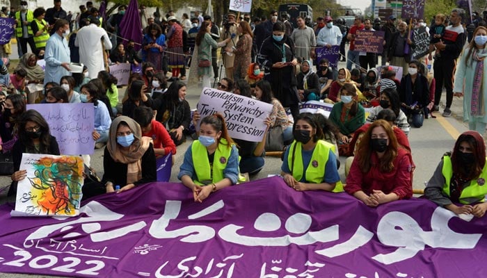 Aurat March protesters hold placards as they gather to mark International Womens Day in Islamabad on March 8, 2022. — AFP