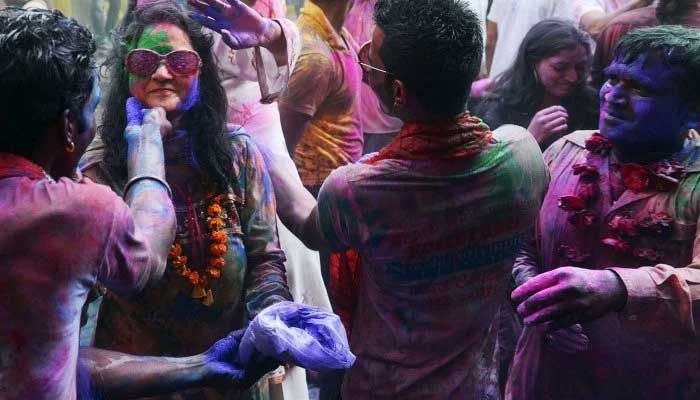 People enjoying the festival of colours. — AFP/File