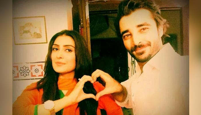 Pakistani actors Ayeza Khan (L) and Hamza Ali Abbasi pose for a picture 10 years ago during a shoot of their drama Pyaar-e-Afzal aired in 2014. — Instagram/@ayezakhan.ak