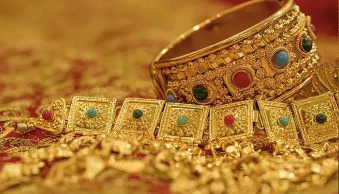 An undated image of gold bangles and a choker is displayed at a store. — AFP