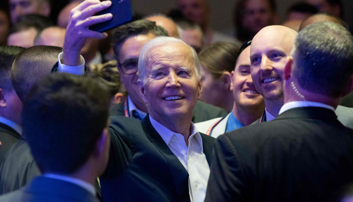 US President Joe Biden takes a selfie with attendees after speaking at the 2023 International Association of Fire Fighters Legislative Conference in Washington, DC, on March 6, 2023. AFP/File