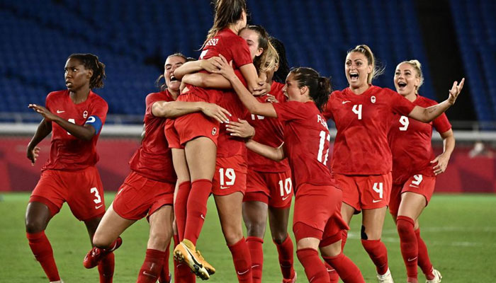 Canadas players celebrate after midfielder Julia Grosso (C) scored the winning penatly during the penalty shoot-out of the Tokyo 2020 Olympic Games womens final football match between Sweden and Canada at the International Stadium Yokohama in Yokohama on August 6, 2021. AFP/File