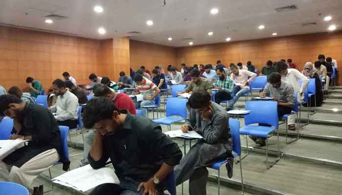 The picture shows students sitting in an examination hall. — Twitter/@umarsaif