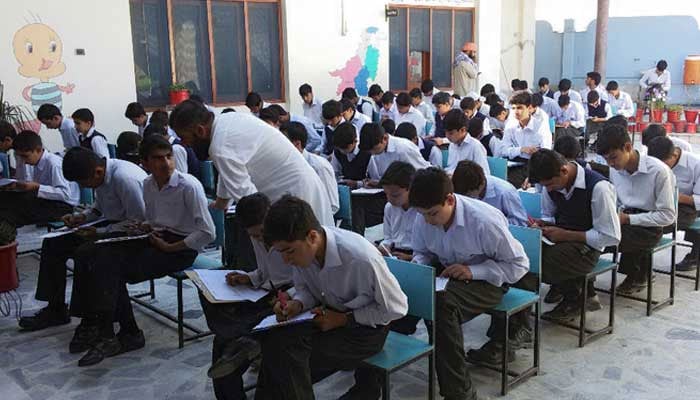 Students sit for an exam in Swat. — APP/File