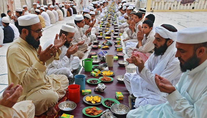 Pakistani Muslims pray before breaking their fast at a mosque during the first day of Ramadan in Peshawar, Pakistan, on July 11, 2013. — AFP