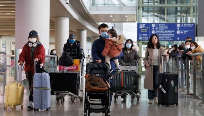 Passengers push their luggage through the international arrivals hall at Beijing Capital International Airport after China lifted the coronavirus disease (COVID-19) quarantine requirement for inbound travellers in Beijing, China January 8, 2023.— AFP