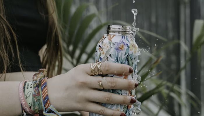 A woman filling up a water bottle.— Unsplash