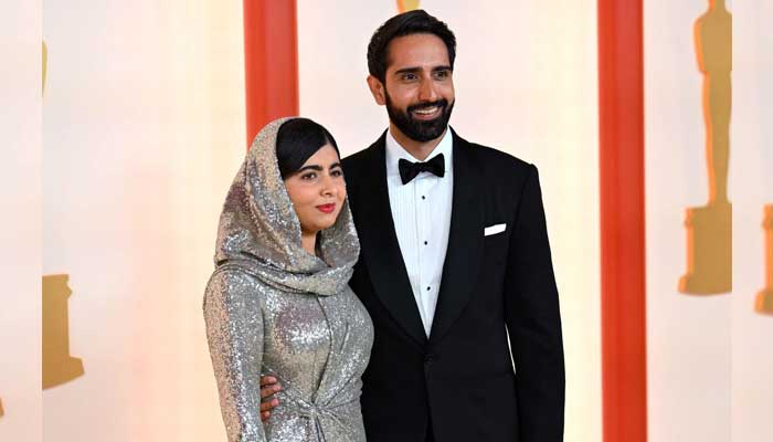 Pakistani activist Malala Yousafzai and her husband ttends the 95th Annual Academy Awards at the Dolby Theatre in Hollywood, California on March 12, 2023. — AFP