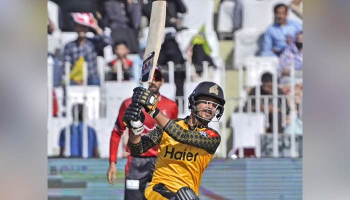 A Peshawar Zalmi batter hits a shot while a Lahore Qalandars wicketkeeper looks on during the 23rd match of the Pakistan Super League (PSL) at the Pindi Cricket Stadium in Rawalpindi on March 7, 2023. — PSL