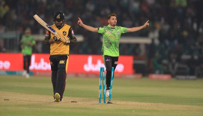 Lahore Qalandars bowler celebrates while a Peshawar Zalmi batter looks disappointed during the second eliminator of the Pakistan Super League (PSL) at the Gaddafi Stadium in Lahore on March 17, 2023. — PSL