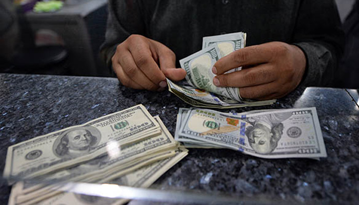 A man counts $100 notes. — AFP/File