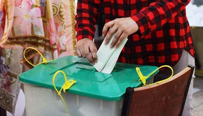 A person drops a ballot paper in a ballot box. — AFP/File