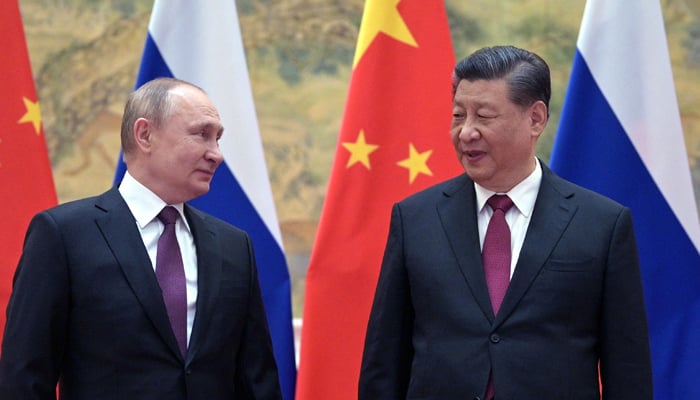 Russian President Vladimir Putin (L) and Chinese President Xi Jinping pose for a photograph during their meeting in Beijing. — AFP/File