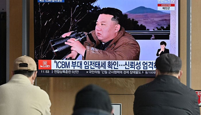 People watch a television news screen showing a picture of North Korea´s leader Kim Jong Un witnessing the recent test-firing of a Hwasong-17 intercontinental ballistic missile (ICBM), at a railway station in Seoul on March 17, 2023.—AFP