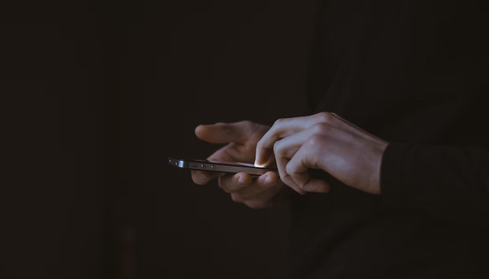 A person is using a mobile phone in this illustrative image. — Unsplash/File