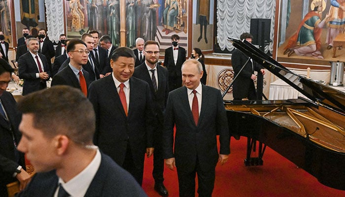 Russian President Vladimir Putin and China´s President Xi Jinping leave after a reception following their talks at the Kremlin in Moscow on March 21, 2023. AFP