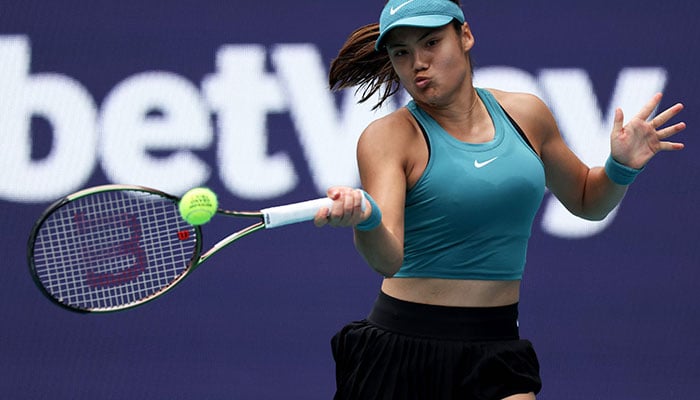 Emma Raducanu of Great Britain plays a forehand against Bianca Andreescu of Canada in their first round match during the Miami Open at Hard Rock Stadium on March 22, 2023 in Miami Gardens, Florida. AFP
