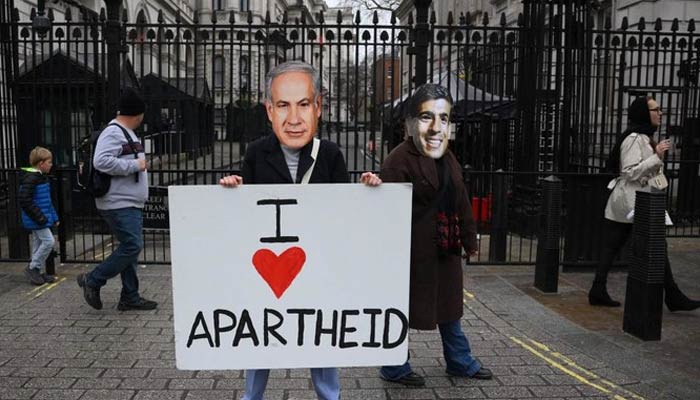 Protesters wearing facemasks of Israel’s Prime Minister Benjamin Netanyahu and Britain’s Prime Minister Rishi Sunak hold a placard outside gates of Downing Street in central London on March 23, 2023. — AFP