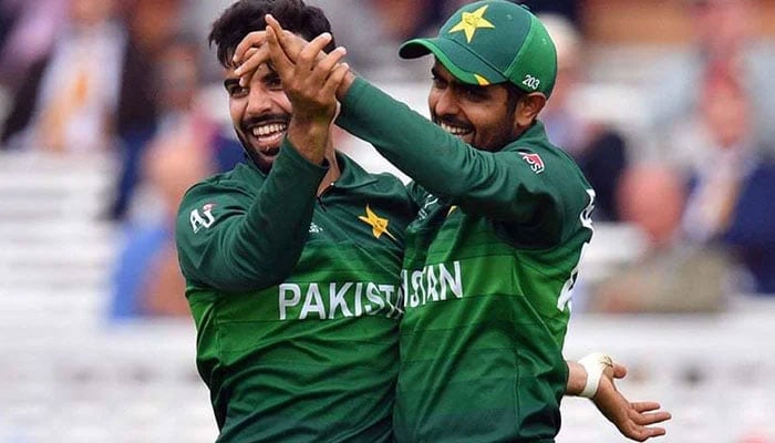 Shadab Khan (L) celebrates with teammate Babar Azam during the 2019 Cricket World Cup group stage match between Pakistan and South Africa at Lords Cricket Ground in London on Sunday. — AFP/File