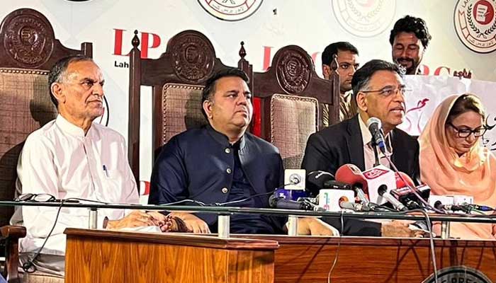 PTI Senator Azam Swati (left), Senior Vice-President Fawad Chaudhry and Secretary General Asad Umar speak during a press conference at Lahore Press Club on March 26, 2023. — Twitter/@PTIofficial