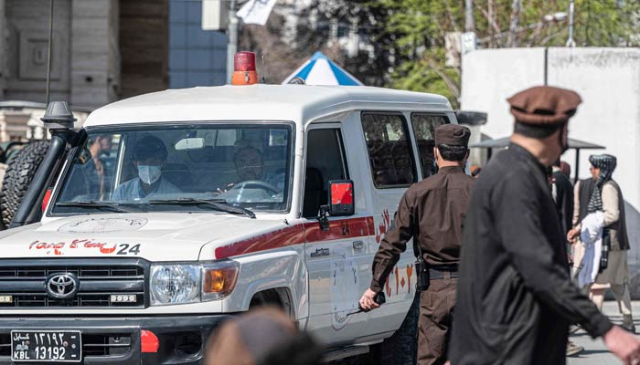 An ambulance carries victims from near the site of a suicide attack in Kabul on March 27, 2023. — AFP