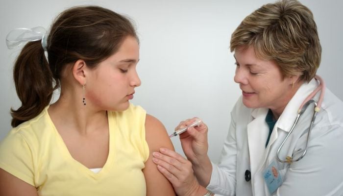 The nurse depicted in this 2006 photograph, was in the process of administering an intramuscular vaccination in the left shoulder of a young girl.— Unsplash