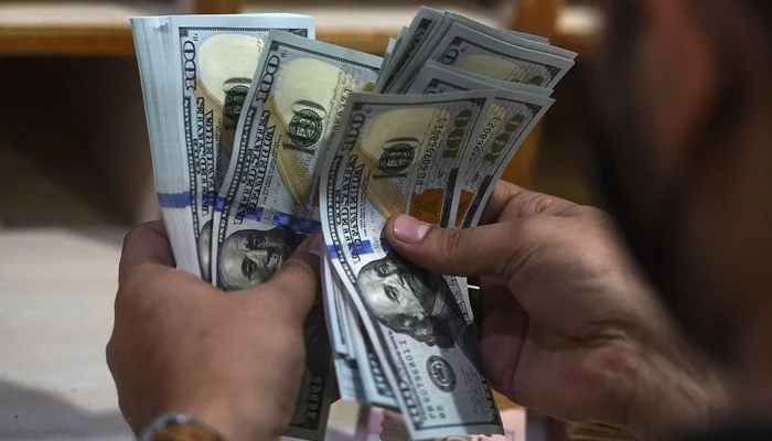 A man counts dollar bills. — AFP