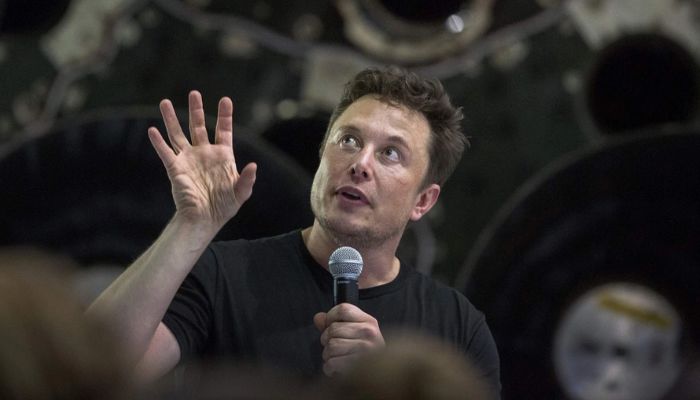 Elon Musk speaks near a Falcon 9 rocket at the SpaceX headquarters and rocket factory in Hawthorne, California, in September 2018.— AFP