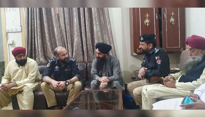 SSP Operations Haroon-ul-Rashid Khan shares his condolences with family members of the Sikh shopkeeper Dayal Singh at his residence on March 31, 2023. — Photo by author
