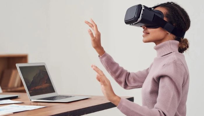 A woman using virtual reality goggles.— Pexels